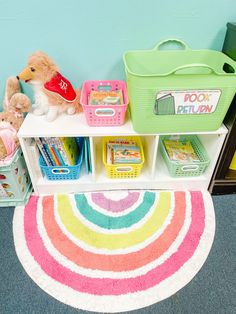 a toy storage area with toys, books and other children's items on it