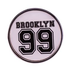 a white and black badge with the number 99 on it that says brooklyn 899