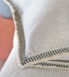 a close up view of a pillow on a couch with the fabric stitched down