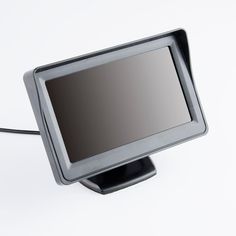 a computer monitor sitting on top of a black stand