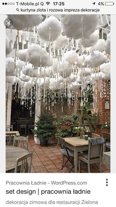 an image of a restaurant with clouds hanging from the ceiling and tables in front of it