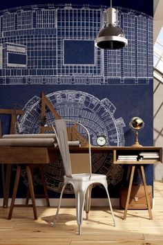 a chair and desk in front of a wall with a blueprint design on it