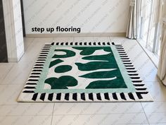 a green and white area rug on the floor