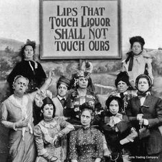 a group of women pose in front of a sign that says lips that touch liquor shall not touch ourss