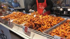 a person standing in front of trays of food