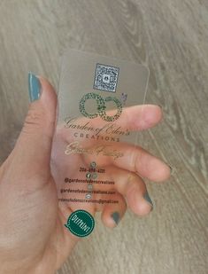 a woman's hand holding up a business card