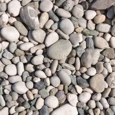 rocks and gravel are arranged together on the ground