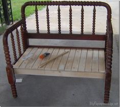 a bench made out of wooden slats with a baseball bat and ball on it