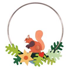 an animal is sitting on top of some green plants and leaves, with a hoop hanging from it's side