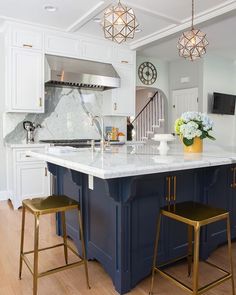 a kitchen island with two stools in front of it