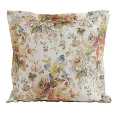 a white pillow with floral print on the front and back, sitting against a white background