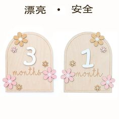 two wooden signs with flowers and numbers on them