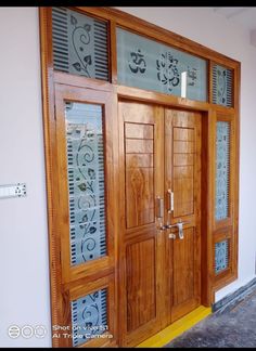 two wooden doors in front of a white wall