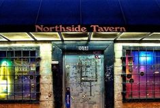 the front entrance to northside tavern in new york city at night with colorful lights