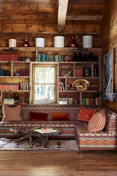 a living room filled with lots of furniture and bookshelves