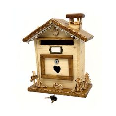 a wooden birdhouse with a heart on the door and window above it's roof