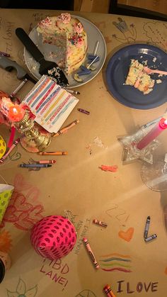 a table topped with lots of different types of cakes and confetti on top of it