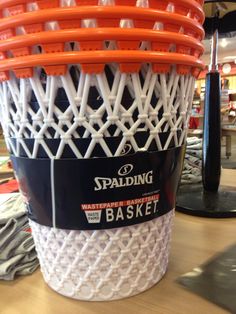 an orange and white basket sitting on top of a table