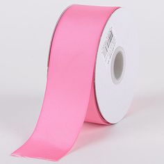 a roll of pink satin ribbon on a white background