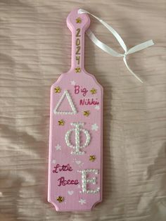 a pink tag with the words big sister and little niece on it hanging from a white ribbon