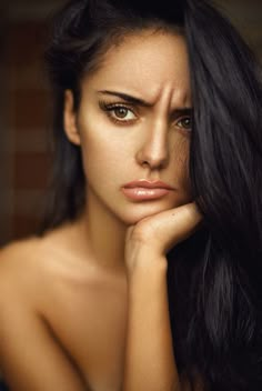 a woman with long black hair and green eyes