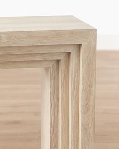 three wooden frames stacked on top of each other in front of a wood flooring area