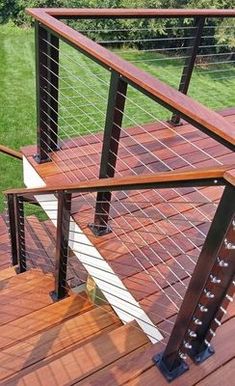 a wooden deck with metal rails and railings