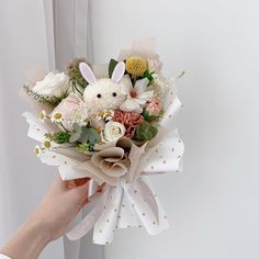 a person holding a bouquet of flowers in their hand