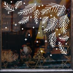 a window with snowflakes and christmas decorations in it