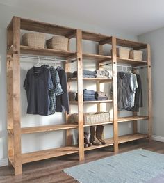 a wooden shelf filled with clothes and baskets