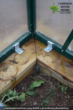 the corner of a window is made out of wood and green plastic covering it's sides