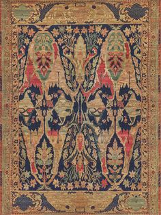 an antique rug with floral designs and leaves on the border, is shown in red, blue