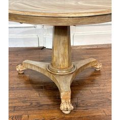 a wooden table sitting on top of a hard wood floor next to a white door