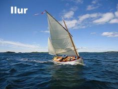 a small sailboat with people on it in the water