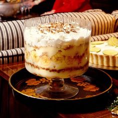 a dessert is sitting on a table with people in the background