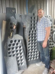 a man standing next to some large pipes