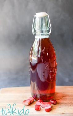 a bottle filled with liquid sitting on top of a wooden table