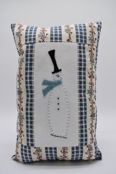 a pillow with a snowman on it