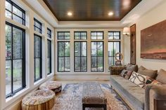 a living room filled with furniture and lots of windows