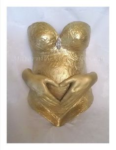 a gold teddy bear with its hands in the shape of a heart, on a white background