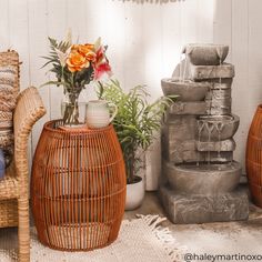 two wicker stools with vases and flowers on them