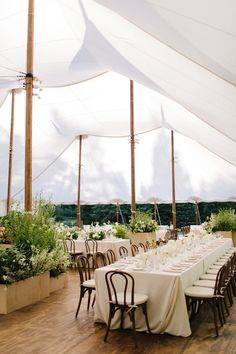 a large tent with tables and chairs set up for an event