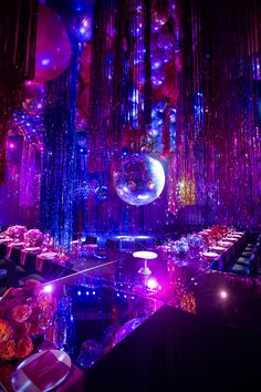 a room filled with lots of purple and blue lights