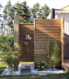 an outdoor shower in the middle of a yard