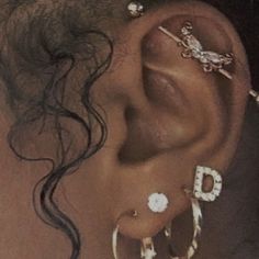 a close up of a person with ear piercings