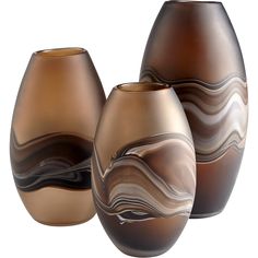 three brown vases sitting next to each other on a white surface with wavy designs