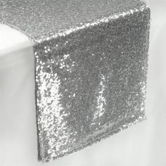 silver sequin table runner on white background