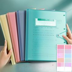 a person holding a binder with several colors in front of them and a hand pointing at it