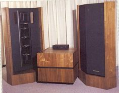 there are two speakers and a cabinet in the room