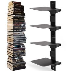 a stack of books sitting on top of a black shelf next to a pile of dvd's